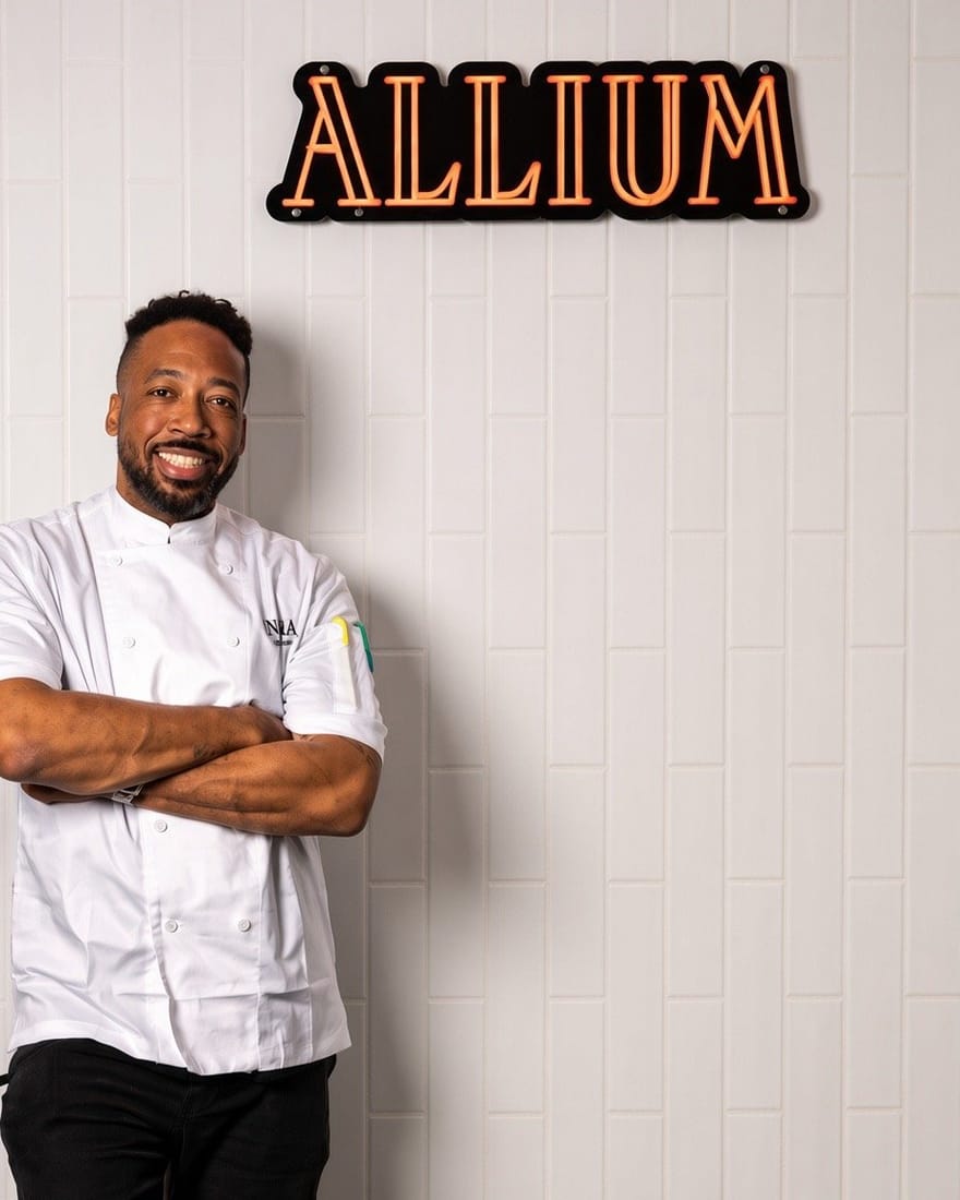 Chef Jason Fullilove in front of the Allium sign