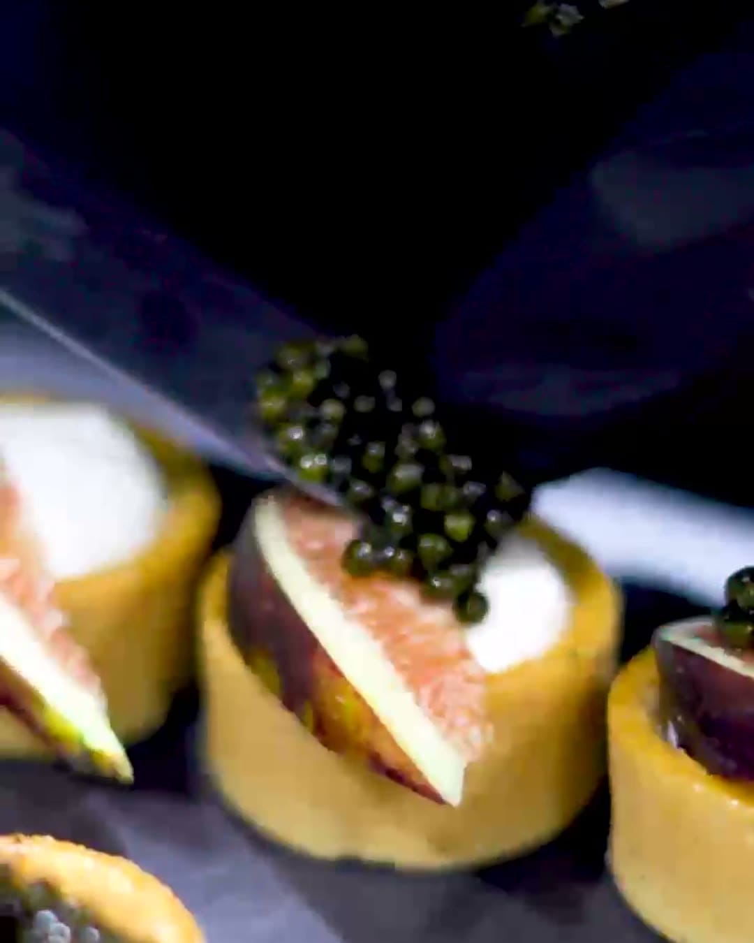 Tartlets topped with caviar and fig